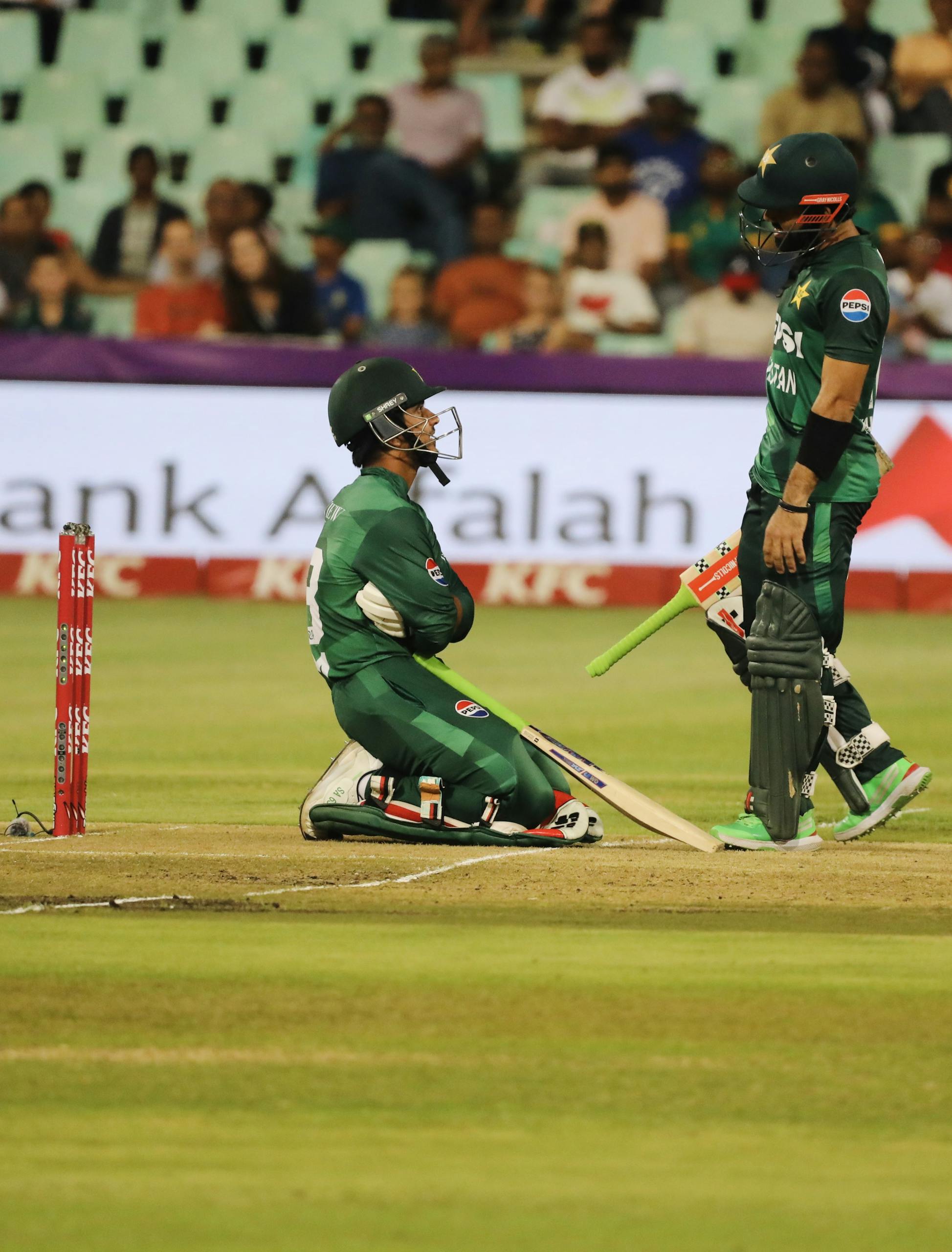 Two cricketers engage in a tense moment on the field during a match.